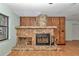 A stone fireplace with wood flooring and wooden wall in a comfortable living area at 6421 Nw 61St St, Ocala, FL 34482