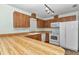 Bright kitchen features white appliances, wood cabinets, and a peninsula countertop at 6421 Nw 61St St, Ocala, FL 34482