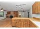Spacious kitchen connects to living area with a stone fireplace and wood accents at 6421 Nw 61St St, Ocala, FL 34482