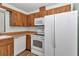 This kitchen is equipped with white appliances, wood cabinets, and modern fixtures at 6421 Nw 61St St, Ocala, FL 34482
