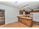 Functional kitchen featuring wood cabinets, modern appliances, and a breakfast bar at 6421 Nw 61St St, Ocala, FL 34482