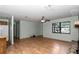 Open-concept living area with wood floors, a stone fireplace, and large window at 6421 Nw 61St St, Ocala, FL 34482