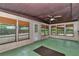 Sunroom features many windows and a back door to the backyard at 6421 Nw 61St St, Ocala, FL 34482