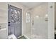 This bathroom boasts a clear glass shower enclosure and unique, colorful door at 727 Seminole Ave, Orlando, FL 32804