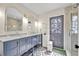 Bathroom boasts dual sinks, stylish blue cabinets, and a glass-enclosed shower at 727 Seminole Ave, Orlando, FL 32804
