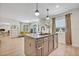 Open concept kitchen flows into living space, featuring kitchen island with modern fixtures and bar seating at 727 Seminole Ave, Orlando, FL 32804