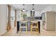 Modern kitchen featuring an island with seating, stainless steel appliances, and stylish pendant lighting at 727 Seminole Ave, Orlando, FL 32804