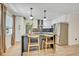 Bright kitchen showcases an island with seating, stainless steel refrigerator, white cabinetry, and modern lighting at 727 Seminole Ave, Orlando, FL 32804