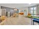 Open floor plan with stylish dining area and decorative gray accent wall, connected to a bright living space at 727 Seminole Ave, Orlando, FL 32804