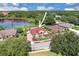 Aerial view of a single-Gathering home near Lake Natasha featuring a red tile roof and well-manicured landscaping at 736 Timacuan Blvd, Lake Mary, FL 32746