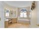 Bright bathroom with a tub and large window. Neutral colors throughout offer a relaxing and clean space at 736 Timacuan Blvd, Lake Mary, FL 32746