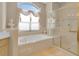 Bright bathroom with soaking tub and glass-enclosed shower at 736 Timacuan Blvd, Lake Mary, FL 32746