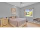 Neutral bedroom featuring a window with natural light and a comfy chair at 736 Timacuan Blvd, Lake Mary, FL 32746
