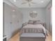 Modern bedroom featuring neutral colors, a ceiling fan, and mirrored side tables at 736 Timacuan Blvd, Lake Mary, FL 32746