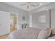 Bedroom featuring neutral colors, a ceiling fan, and a side view to a bathroom at 736 Timacuan Blvd, Lake Mary, FL 32746