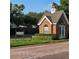 Charming brick guardhouse at the entrance of Timacuan, featuring manicured landscaping and clear signage at 736 Timacuan Blvd, Lake Mary, FL 32746