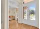 Bright entryway features decorative glass doors, transom window, and hardwood floors at 736 Timacuan Blvd, Lake Mary, FL 32746