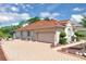 Elegant home with a red tile roof and an expansive patterned brick driveway, complemented by manicured landscaping at 736 Timacuan Blvd, Lake Mary, FL 32746