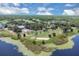 Scenic aerial view of a golf course with ponds, sand traps, and verdant fairways under a partly cloudy sky at 736 Timacuan Blvd, Lake Mary, FL 32746