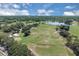 Expansive aerial view of a golf course with ponds, bunkers, and mature trees, showcasing a scenic and challenging layout at 736 Timacuan Blvd, Lake Mary, FL 32746