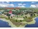 Aerial shot of Timacuan Club's lush golf course with water features, sand traps, and mature trees against a blue sky at 736 Timacuan Blvd, Lake Mary, FL 32746