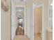 Hallway connecting a bedroom to a bathroom, with wooden floors and neutral color tones at 736 Timacuan Blvd, Lake Mary, FL 32746