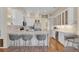 Modern kitchen features white cabinets, stainless steel appliances, and a stylish breakfast bar at 736 Timacuan Blvd, Lake Mary, FL 32746