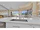 Open kitchen with quartz countertops and stainless steel appliances with view to the living room at 736 Timacuan Blvd, Lake Mary, FL 32746