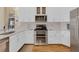 Well-equipped kitchen with sleek white cabinets, stainless steel appliances, and modern countertops at 736 Timacuan Blvd, Lake Mary, FL 32746