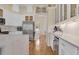 Stylish kitchen featuring white cabinets, stainless steel appliances, and an adjacent wine cooler at 736 Timacuan Blvd, Lake Mary, FL 32746