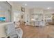 Open living room with wet bar and views to the formal living room and outdoor pool at 736 Timacuan Blvd, Lake Mary, FL 32746