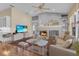 Comfortable living room with fireplace, TV, built-in shelving, and cozy seating at 736 Timacuan Blvd, Lake Mary, FL 32746