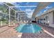 Screened-in pool area features a relaxing hot tub and ample space for entertaining at 736 Timacuan Blvd, Lake Mary, FL 32746