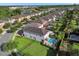 Expansive aerial view showing backyard pools, manicured landscaping and neighborhood streets near a scenic lake at 7524 Marker Ave, Kissimmee, FL 34747