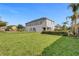 Expansive backyard featuring lush green grass and a well-manicured perimeter hedge at 7524 Marker Ave, Kissimmee, FL 34747