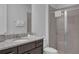 Well-appointed bathroom featuring granite countertops, modern fixtures, and glass-enclosed shower at 7524 Marker Ave, Kissimmee, FL 34747