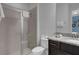 Tiled shower with glass, sleek vanity, and tiled flooring add elegance to this bathroom at 7524 Marker Ave, Kissimmee, FL 34747