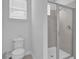 Clean bathroom with a glass shower enclosure and a toilet, perfect for modern living at 7524 Marker Ave, Kissimmee, FL 34747