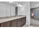 Elegant bathroom featuring double vanities, granite countertops, and wood cabinetry at 7524 Marker Ave, Kissimmee, FL 34747
