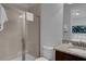 Well-lit bathroom featuring a glass shower, neutral tile, and sleek granite countertops at 7524 Marker Ave, Kissimmee, FL 34747