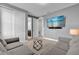 Cozy bedroom with gray walls, sliding door closet, TV, and stylish furniture at 7524 Marker Ave, Kissimmee, FL 34747