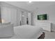 Large bedroom with white walls, carpeted floors, and large television creates a calming vibe at 7524 Marker Ave, Kissimmee, FL 34747