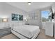 Bright bedroom with minimalist style, showcasing natural light, a TV, and a contemporary aesthetic at 7524 Marker Ave, Kissimmee, FL 34747