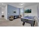 Game room with air hockey table, blue accent wall, and mounted TV creates a fun ambiance at 7524 Marker Ave, Kissimmee, FL 34747