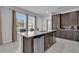 Bright kitchen features a granite island, stainless steel appliances, and wooden cabinets at 7524 Marker Ave, Kissimmee, FL 34747