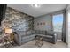 Cozy living room with unique wallpaper, a comfortable gray sectional sofa, and stylish decor at 7524 Marker Ave, Kissimmee, FL 34747