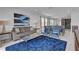 Comfortable living room with plush seating, a blue rug, and an open layout to the kitchen and dining area at 7524 Marker Ave, Kissimmee, FL 34747