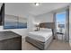 Comfortable main bedroom featuring an upholstered headboard, side tables, and a peaceful ambiance with a view at 7524 Marker Ave, Kissimmee, FL 34747