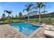 Inviting pool with a spa surrounded by tropical palm trees and manicured hedges at 7524 Marker Ave, Kissimmee, FL 34747
