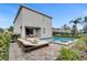 Inviting pool area with a patio, lounge chair, grill, and outdoor dining set at 7524 Marker Ave, Kissimmee, FL 34747